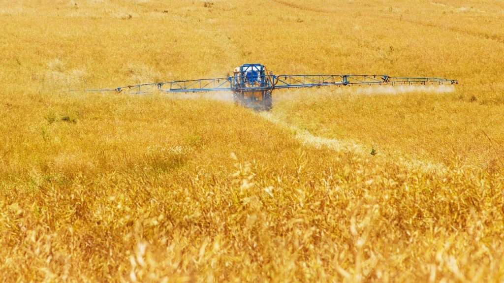 Tractor spraying in a field - glyphosate